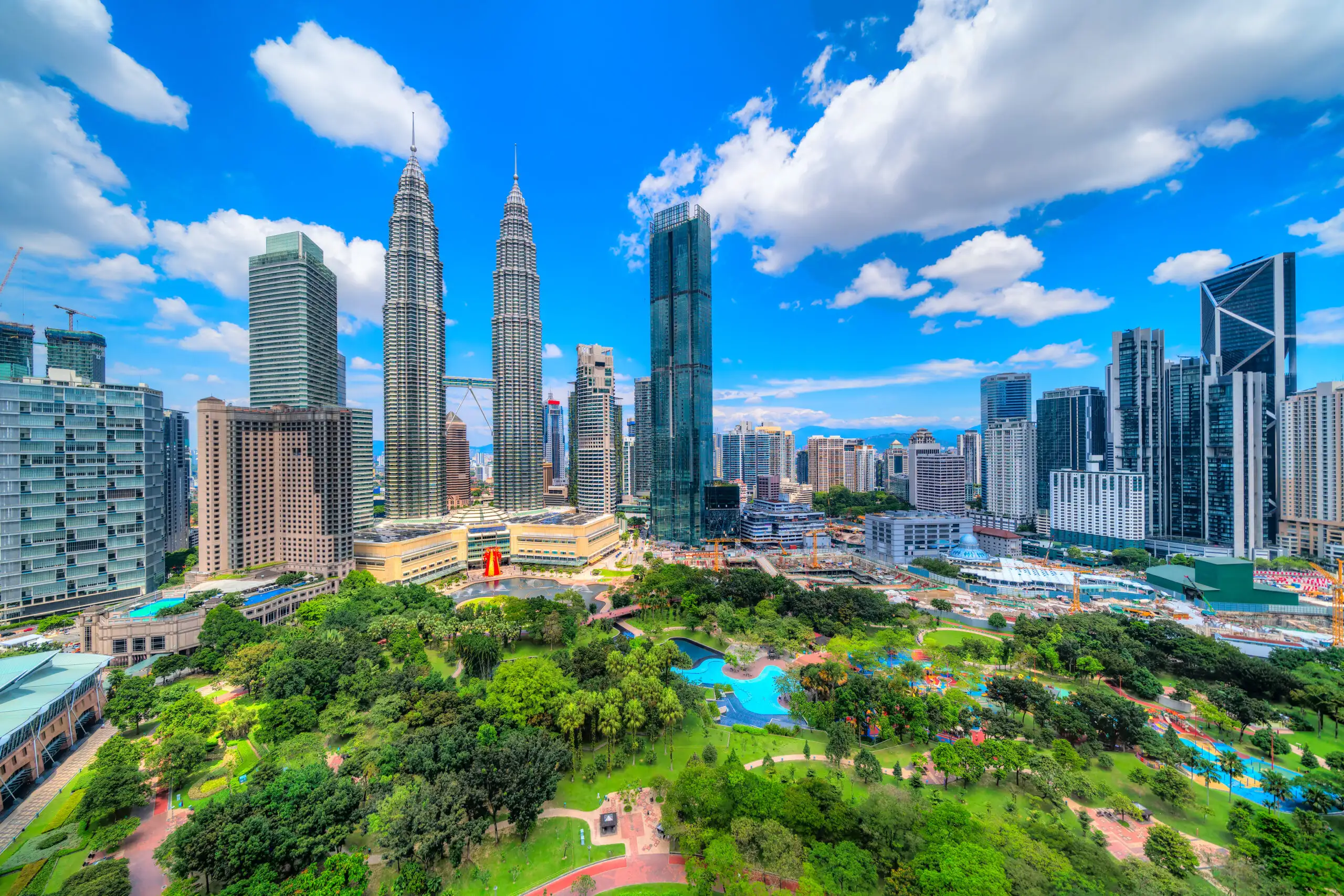 PETRONAS Twin Towers and KLCC Park under a blue sky in Kuala Lumpur
