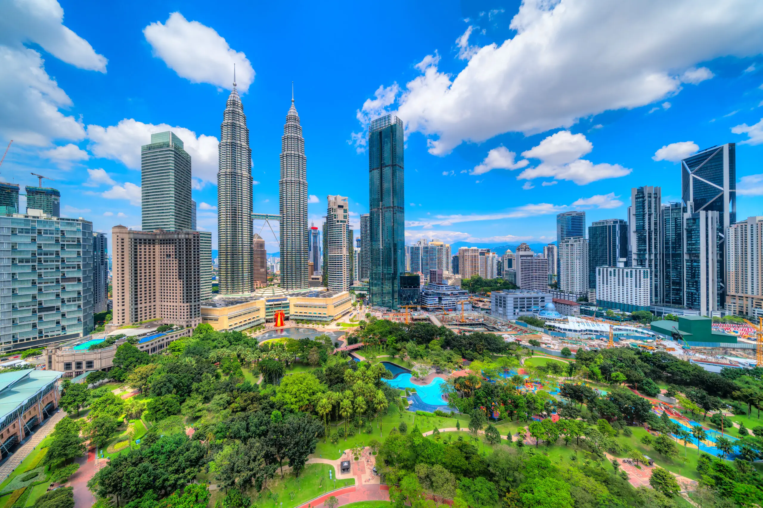 PETRONAS Twin Towers and KLCC Park under a blue sky in Kuala Lumpur