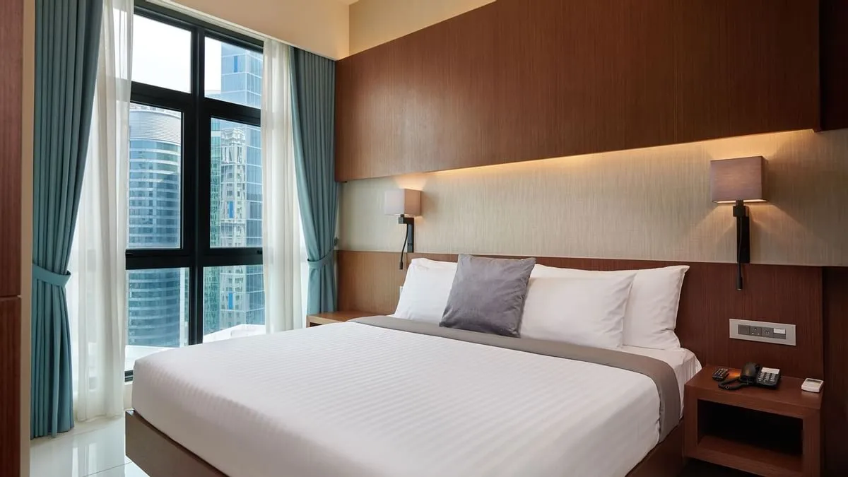 Duo Suite: Bedroom with a King-sized bed beside floor-to-ceiling windows