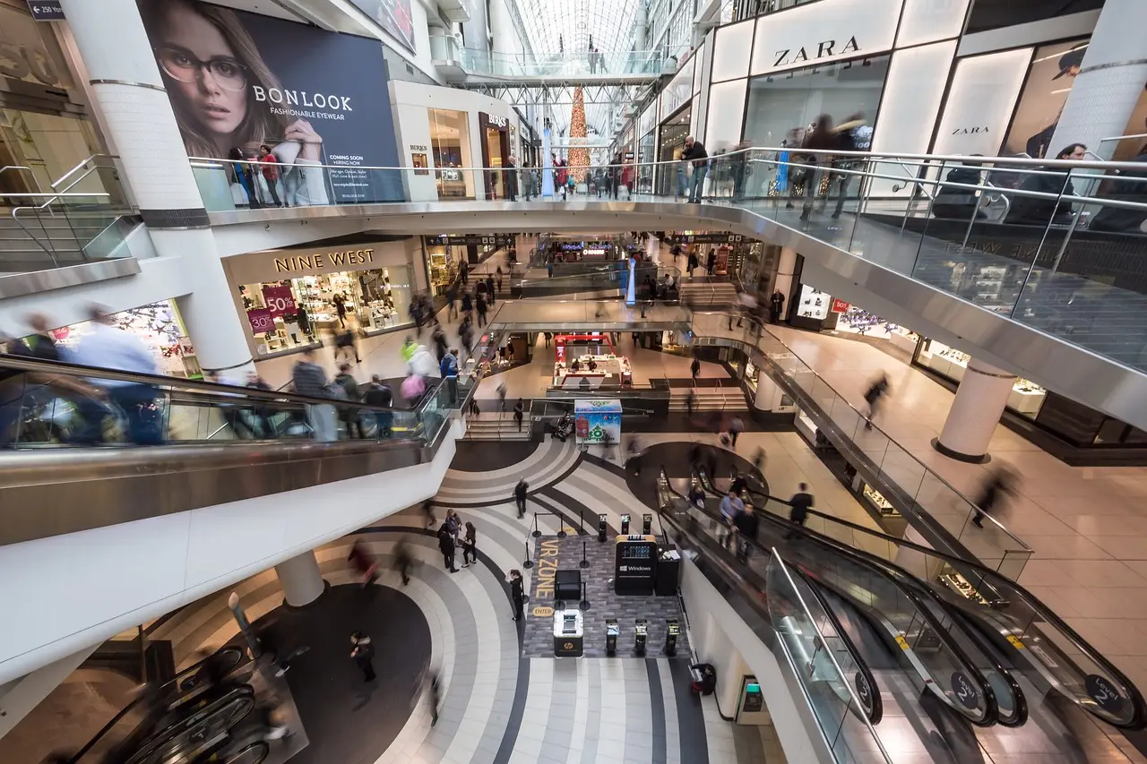 Escalators and shopfronts around the atrium of a Kuala Lumpur shopping mall