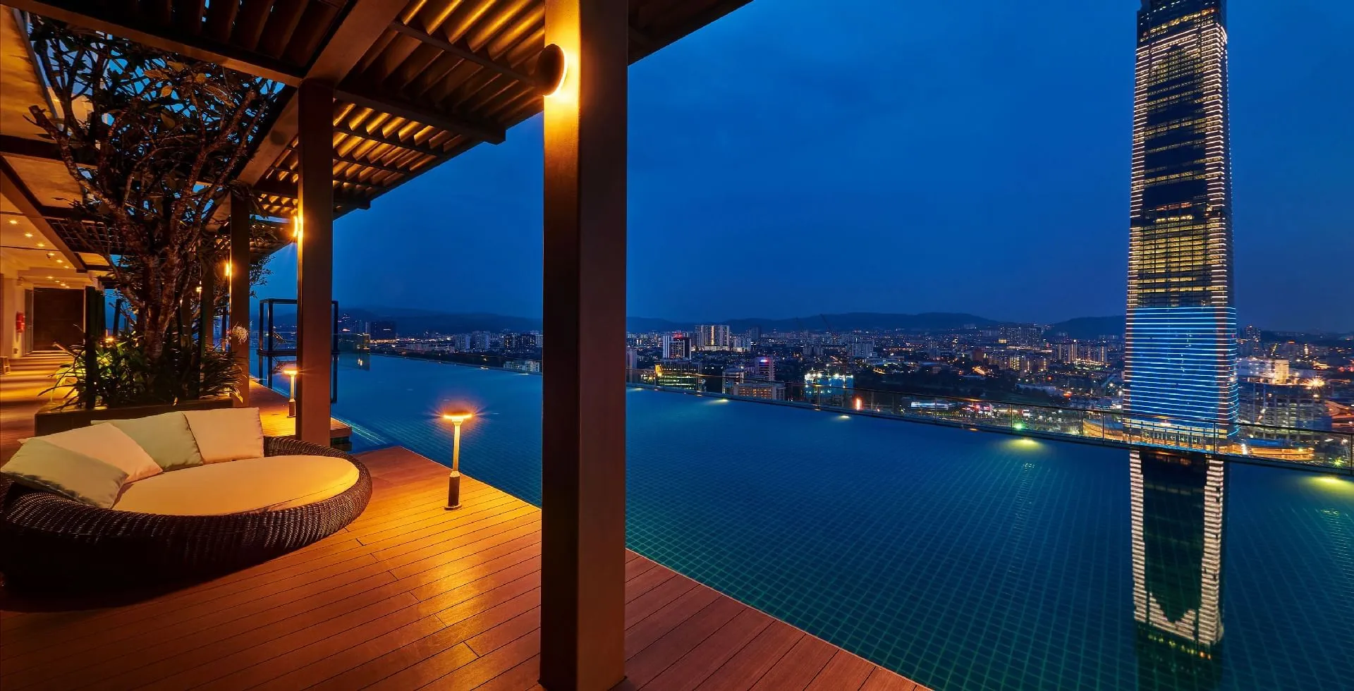 Rooftop sundeck and infinity pool at Tribeca Serviced Hotel, overlooking the Kuala Lumpur skyline at night