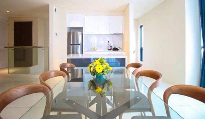 Pinnacle Suite: Glass dining table for six facing the kitchen